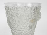 a glass vase that has a flower design on it