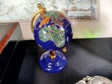 a picture of a blue and gold globe sitting on a table