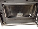 a silver oven with a metal door that has a toaster oven inside of it