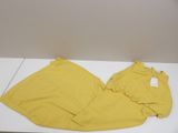 yellow pants on a white table with a tag on it