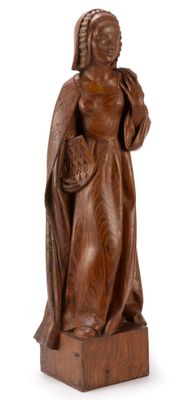 an old wooden statue of a woman holding a basket