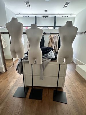 three mannequins on display in a clothing store