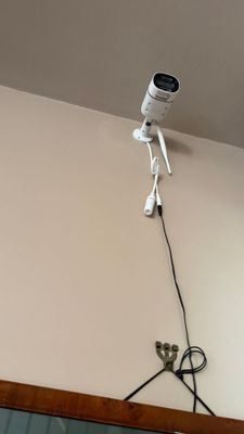 a camera mounted on the wall above a mirror