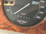 a close up of a speedometer on a wooden table