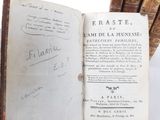 an old book with writing on it sitting on a table