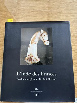 the book is sitting on a table with a white horse on it