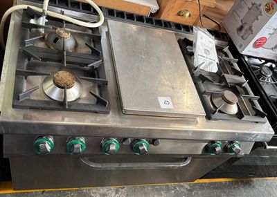 a silver stove top with four burners on it