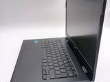 a laptop computer sitting on a table with a keyboard