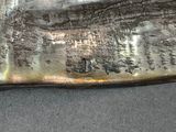 a metal object with writing on it sitting on a table
