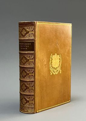 an old book sitting on top of a table next to a gray wall