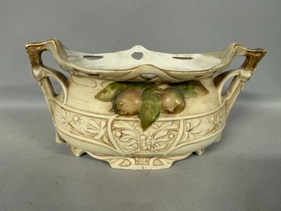 a white bowl with fruit on it sitting on a table