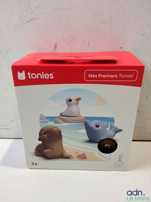 the box is open on the table with a toy animal on it