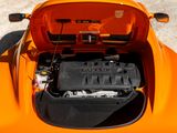 a close up of an orange car with a battery in the trunk