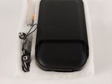 a black cell phone sitting on top of a white cloth