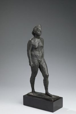 an image of a bronze statue of a woman standing on a black base