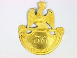 an image of a gold badge with a bird on it