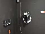 des toilettes dans un coin d'une salle de bains, avec un casque accroché au mur