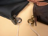 a black bag with a brown handle and a brown bag with a brown handle and a brown bag with a brown handle and a brown bag with a brown