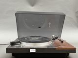 an image of a record player sitting on top of a wooden table