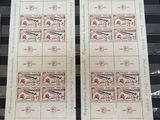 two stamps with a picture of a plane on them on a table