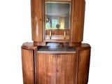 a wooden cabinet with a mirror on top of it