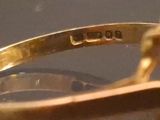 a close up of a gold ring with a diamond on it