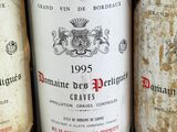 several bottles of wine are lined up on a shelf
