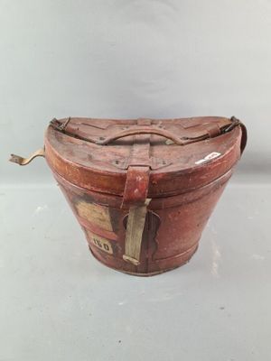 a brown bag with a tag on it sitting on a white surface