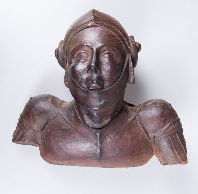 an old wooden bust of a woman with a helmet on her head