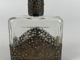 an image of a glass bottle with beads in it on a white surface
