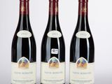 three bottles of wine sitting on top of a white table