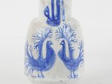 a blue and white vase with two birds on it