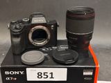 a camera and a lens sitting on top of a box