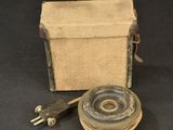 an old fashioned camera with a canvas case and a metal object
