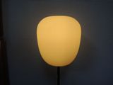 the lamp is lit up against the wall in the dark