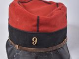 a red and black hat with the number 9 on it