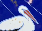 a blue and white sign with a bird on it