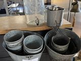 many buckets of water sitting on a table