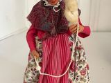 an image of a figurine of a woman with a bird in her hand