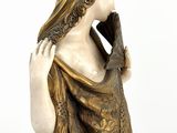 statue of a woman with a veil on her head and a scarf around her neck