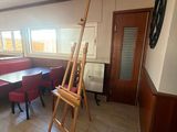 a room with a table, chairs, and a ladder in it