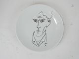 a plate with a drawing of a man ' s face on it