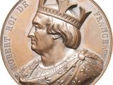 an image of a close up of a medal with a crown on it