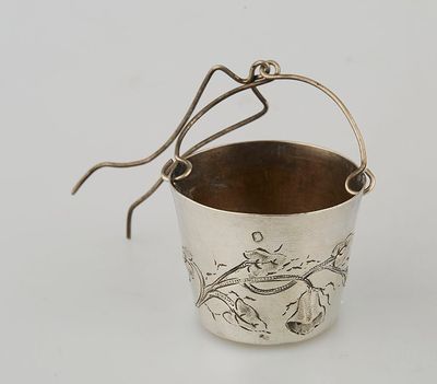 a silver cup with a handle and a handle on the handle