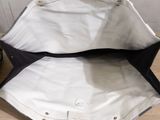 a black and white purse sitting on a table next to a pair of shoes