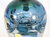 a glass vase with a blue and yellow design on it