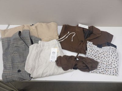 une table sur laquelle sont posés beaucoup de vêtements
