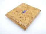 a small wooden box with a blue emblem on it