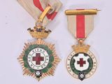 two medals with a red cross and a medal on a white background