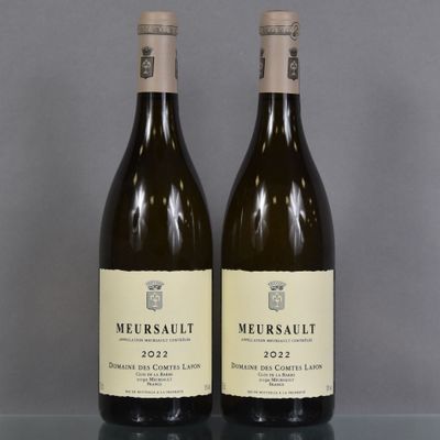 two bottles of wine sitting on top of a table next to each other